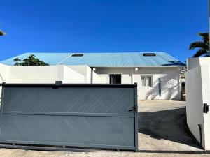 a gray garage door in front of a house at La villa Selah **** in Saint-Louis