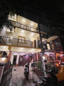 a man on a motorcycle parked in front of a building at The cozy Inn in Calangute