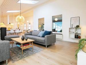 a living room with a couch and a table at 5 star holiday home in Sæby in Sæby