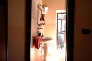 a bathroom with a sink next to a door at La Casa Nel Corso in Pitigliano +17 photos