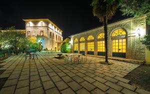 a building with tables and chairs in a courtyard at night at Villa Dell'Annunziata in Rieti