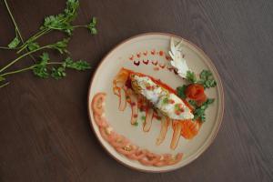 a plate of food with fish and shrimp on a table at Ayati Resort & Spa in Panchgani