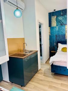 a kitchen with a sink and a bed in a room at Il Rifugio Del Mare in Salerno +9 photos