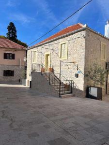 a brick building with stairs on the side of it at Tri Srca 1 - De Luxe 1 in Trebinje +12 photos