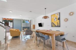 a dining room with a wooden table and chairs at Casa Alicia in Corralejo