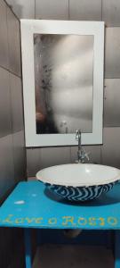 a bathroom with a sink and a mirror at Espacio chill hostel in Búzios