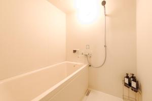 een badkamer met een bad en een douche bij TDR車9分 3BR 5Bed 夢の続きを楽しめる宿 -TAMU-LAND Kasai- in Tokyo +36 foto's