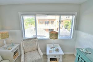 a living room with a chair and a window at Seagrass Flats in Ilexhurst