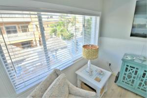 a living room with a large window and a chair at Seagrass Flats in Ilexhurst