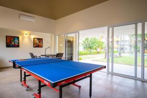 a ping pong table in a living room with at Cloud Line by Leo Homes - 2BHK near Anjuna Beach in Anjuna