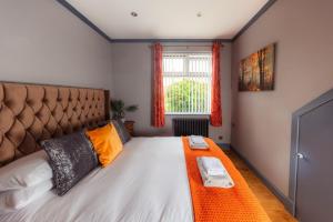 a bedroom with a large bed and a window at Hamara Luxury Portree Cottage with Hot Tub! in Portree
