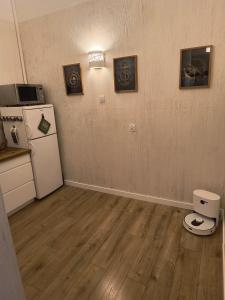 an empty room with a refrigerator and a kitchen at Kindermann Residence in Łódź +12 photos