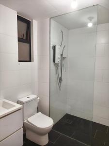a white bathroom with a toilet and a shower at SQ31 Sq where 55 inch 4 ktv sungai buloh in Shah Alam +17 photos