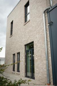 a brick building with a large glass door at Apartment Fürstenau in Fürstenau