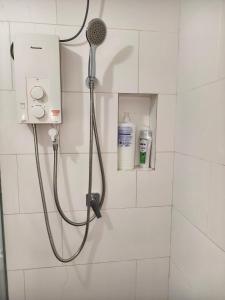 a shower with a shower head in a bathroom at SQ31 Sq where 55 inch 4 ktv sungai buloh in Shah Alam