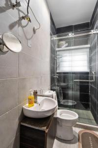a bathroom with a sink and a toilet and a shower at Bethel in Lagos
