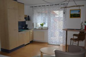 a kitchen with a wall with a geometric pattern at Komfort-Apartment Mit Terrasse in Estenfeld