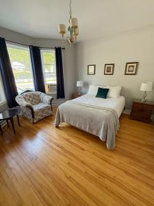 a bedroom with a bed and a chair at Waterfordbridge Apartments - 2 Bedroom Mainfloor in St. John's