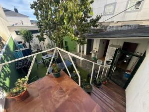 a balcony with potted plants on a house at ALBERGUE Pasiño A Pasiño in Portomarin