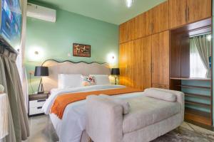 a bedroom with a large bed and a chair at Bethel in Lagos