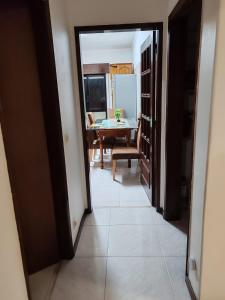 a hallway leading to a dining room with a table at Double room in shared house in Santarém