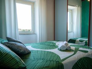 a bedroom with two beds with towels on them at Casa Margot by Holiday World in Caprarola