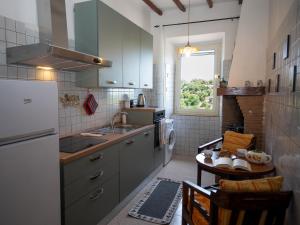 a kitchen with a sink and a table in it at Casa Margot by Holiday World in Caprarola +8 photos