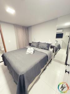 a bedroom with a bed with two towels on it at Paradise Flat 104 in Nossa Senhora do Livramento