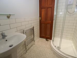 a bathroom with a sink and a shower at 11 Hollin Well Cottage in Sowerby Bridge