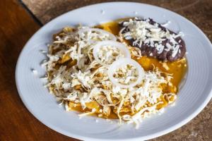 a white plate of food on a table at Capital O Nueva York, Guadalajara centro downtown in Guadalajara +41 photos