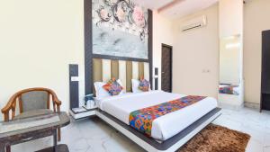 a bedroom with a large white bed and a chair at Golden Spoon in Jāmb