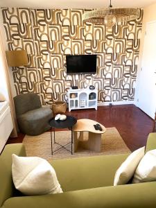 a living room with a couch and a tv at -La Casa d'Avignon- in Avignon