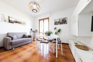 a living room with a table and a couch at High Views at Castel Rocchero in Castel Rocchero