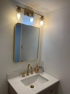 a bathroom with a sink and a mirror at 5 Min walk to Stony Brook University in Stony Brook +19 photos