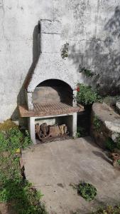 a stone pizza oven sitting against a wall at Maison de la mer in Brétignolles-sur-Mer
