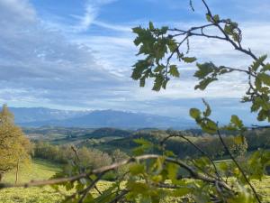 a view of a valley from a hill with mountains at Terrasse des Chambarans - Panorama sur le Vercors in Bessins