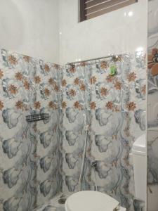 a bathroom with a toilet and a shower curtain at Homestay Tirupati 2bhk near Alipiri kapilathertham in Tirupati