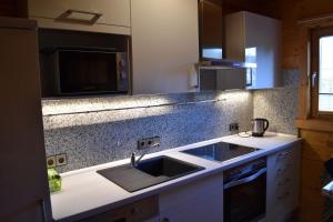 a kitchen with a sink and a microwave at Unser Landhaus - Lastering Ferienhäuser & Apartments in Wettringen +11 photos