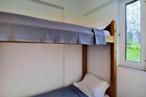 two bunk beds in a room with a window at Villa Cleo in Kalamaki +12 photos