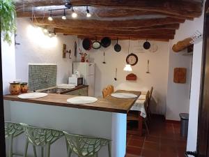 a kitchen with a counter with plates on it at El Paraje de la Platera in Bérchules