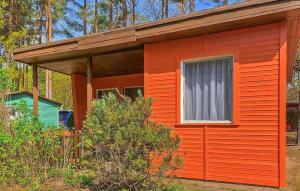 a small red house with a window and a window at Fh Orange in Warenthin +6 photos