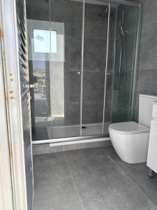 a bathroom with a glass shower and a toilet at Costas court in Limassol
