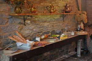 a table with food on a stone wall at La Forge - Chambres d'hôtes en Ardenne in Wellin