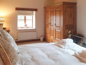 a bedroom with a large white bed and a window at Flatts Barn in Hebden