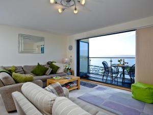 a living room with a couch and a large window at Harbreck Heights -Masts B9 in Torquay