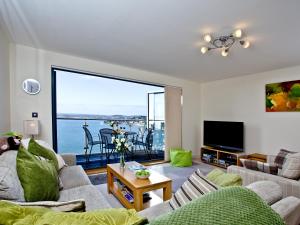 a living room with a view of the ocean at Harbreck Heights -Masts B9 in Torquay