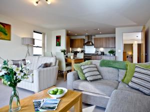 a living room with a couch and a table at Harbreck Heights -Masts B9 in Torquay