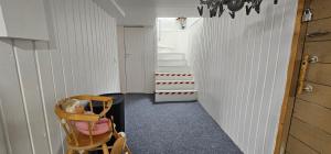 a hallway with a chair and some stairs at Air contioned and furnished half of semi detached house in Rauma
