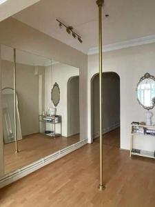 a large room with mirrors and a wooden floor at Sin House in Pamukkale