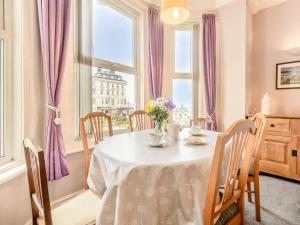 a dining room with a table and a window at Buoy On The Bay in Bridlington
